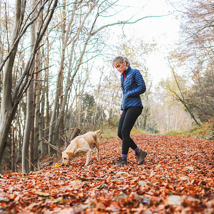 Woman with dog walking in Harz forests 